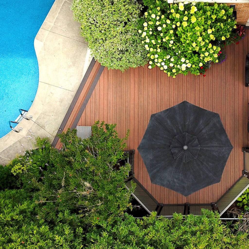 Durable PVC decking in warm brown tones around poolside