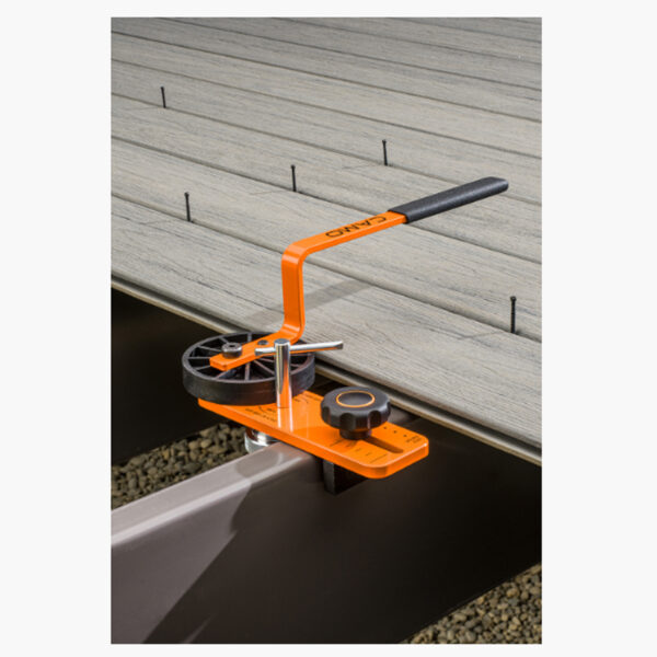 CAMO LEVER tool being used to press deck boards into place before fastening with CAMO Wedge Metal Clips